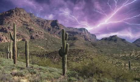 Desert landscape with lightning in sky